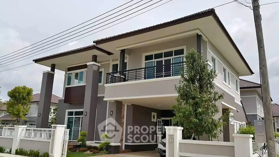 Modern two-story house with spacious balcony and contemporary design.