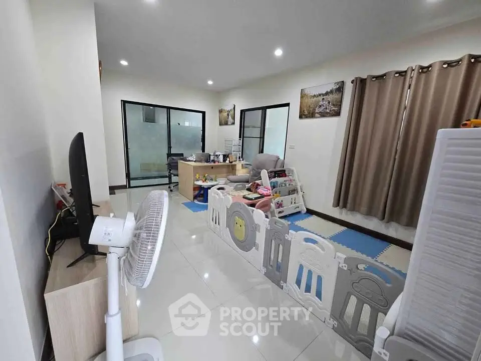 Spacious living room with modern decor and children's play area