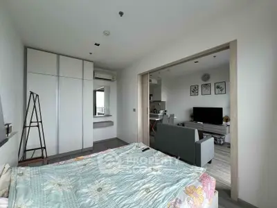 Modern open-layout bedroom with stylish decor and adjacent living area