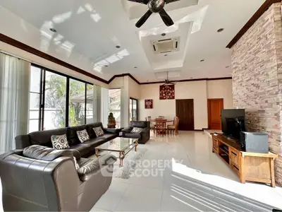 Spacious living room with modern decor and ample natural light