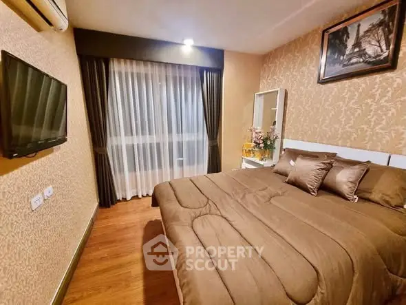 Cozy bedroom with elegant decor and wall-mounted TV in modern apartment