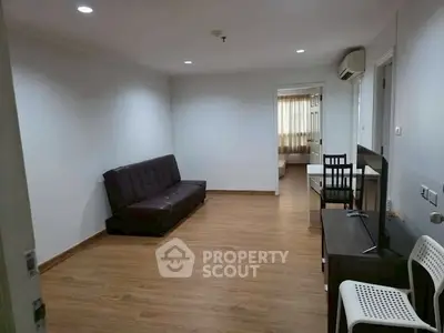 Spacious living room with modern furnishings and wooden flooring