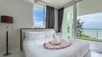 Luxurious bedroom with ocean view and elegant decor, perfect for a serene retreat.