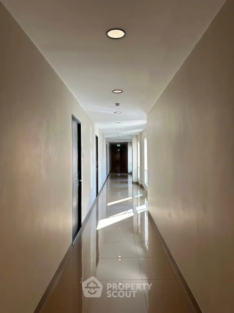 Sleek modern hallway with polished floors and recessed lighting