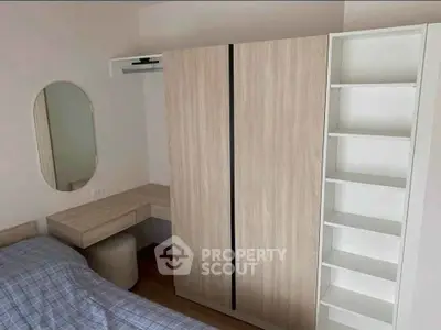 Cozy bedroom with modern wardrobe and study desk, perfect for comfortable living.