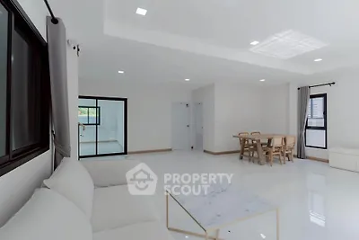 Spacious modern living room with elegant dining area and natural light