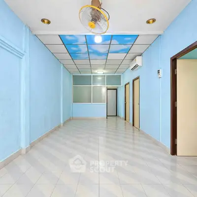 Spacious empty room with sky-themed ceiling and tiled floor, ideal for customization.