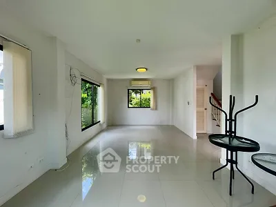 Spacious unfurnished living room with large windows and glossy tile flooring