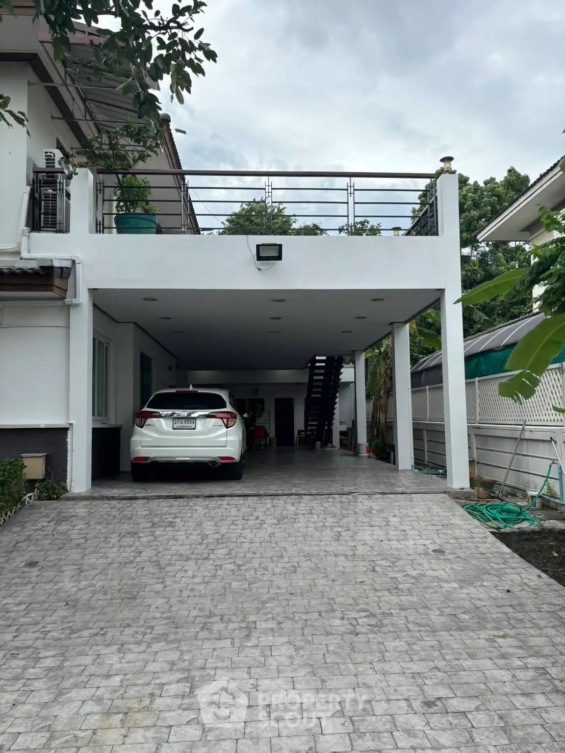 Spacious modern home with covered parking and sleek exterior design