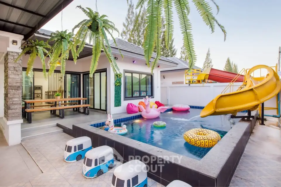 Charming backyard with pool, slide, and playful decor perfect for family fun and relaxation.