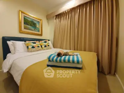 Cozy bedroom with stylish decor and warm lighting, featuring a comfortable bed and elegant curtains.