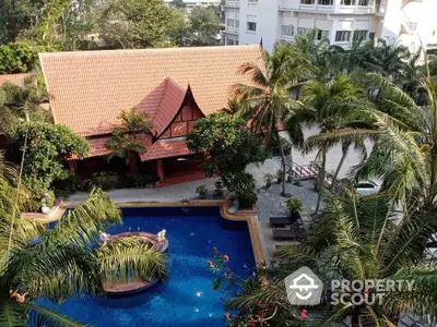 Stunning aerial view of tropical resort with pool and lush palm trees