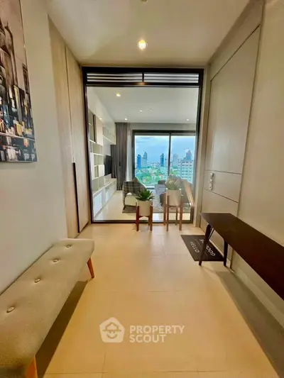 Modern apartment entrance with view of city skyline through large windows.