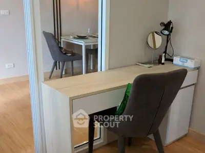 Modern study area with sleek desk and comfortable chair in a stylish apartment.