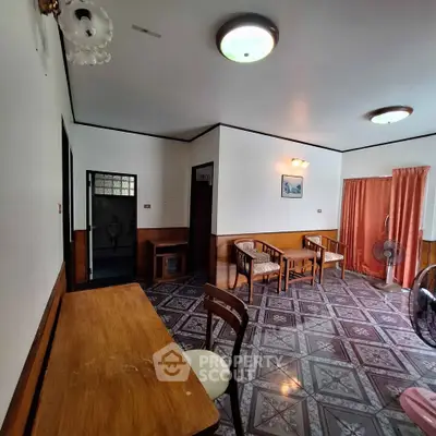 Spacious living room with vintage decor and patterned tile flooring