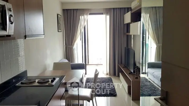 Modern apartment living room with open kitchen and balcony view