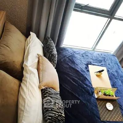Cozy bedroom with stylish bedding and large window for natural light