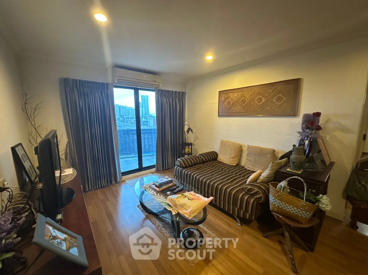 Cozy living room with city view, featuring stylish decor and comfortable seating.