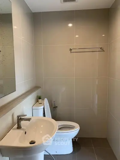 Modern bathroom with sleek fixtures and neutral tiles