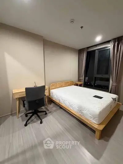 Modern bedroom with minimalist design, featuring a comfortable bed and study desk by a large window.