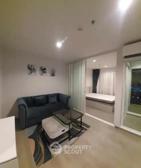 Modern living room with stylish decor and adjacent bedroom in a contemporary apartment.