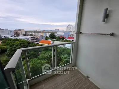 Stunning balcony view overlooking lush greenery and cityscape, perfect for relaxation.