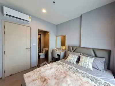 Modern bedroom with ensuite bathroom and stylish decor in a contemporary apartment.