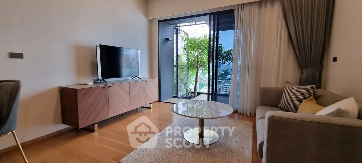 Modern living room with sleek furniture and large window offering stunning city view.