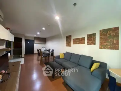 Spacious living room with modern decor and comfortable seating in a stylish apartment.