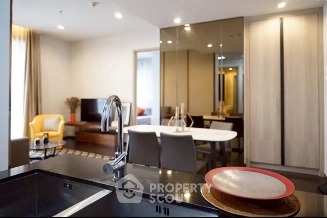 Modern open-plan living room with sleek kitchen and stylish dining area.