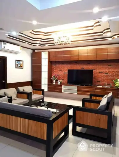 Modern living room with stylish ceiling design and brick accent wall