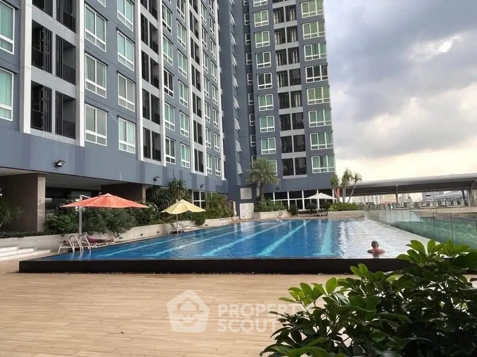 Luxurious high-rise building with stunning poolside view and modern amenities.