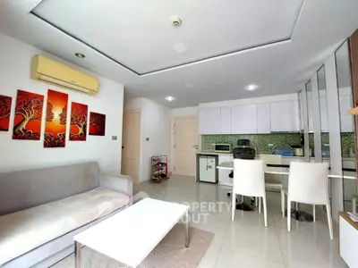 Modern open-layout living room with sleek kitchen and stylish decor