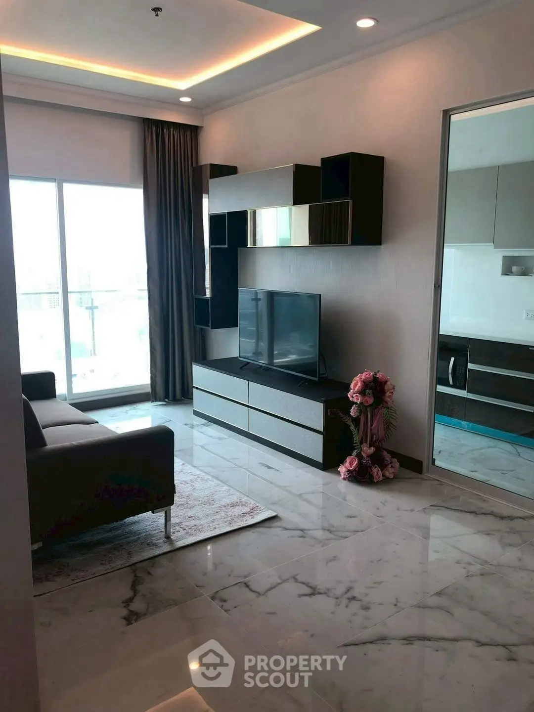 Modern living room with marble flooring and large window offering city view