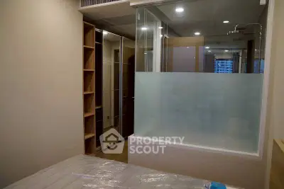 Modern bedroom with glass partition and built-in storage