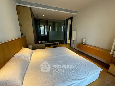 Modern bedroom with sleek design and wooden accents in luxury apartment.
