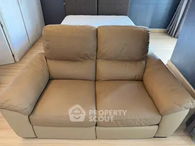 Cozy living room with a comfortable brown leather sofa and stylish decor.