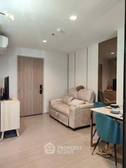 Modern living room with cozy sofa and dining area in stylish apartment.