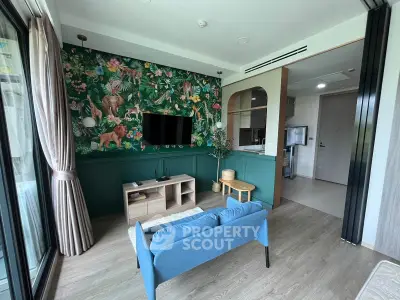 Stylish living room with vibrant jungle-themed wallpaper and modern furnishings in a contemporary apartment.