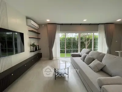 Spacious modern living room with large windows and elegant decor