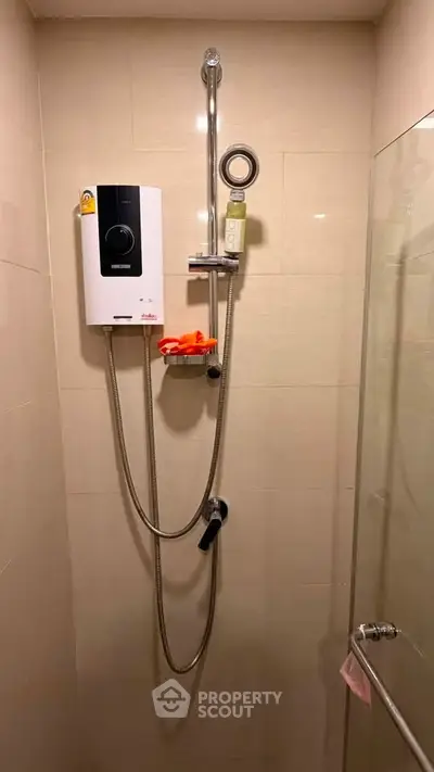 Modern bathroom shower with water heater and glass door enclosure