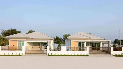 Modern twin single-story homes with sleek design and spacious driveways in a serene neighborhood.