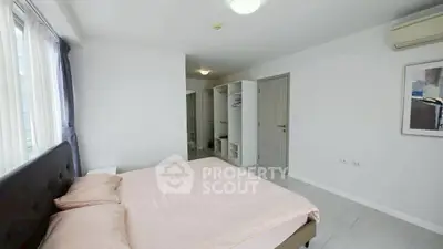 Spacious bedroom with modern decor and ample natural light