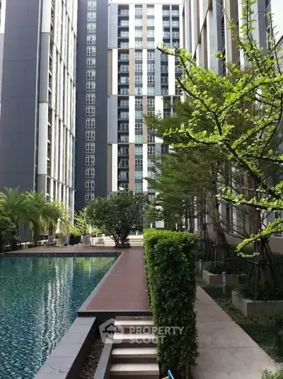 Modern residential building with lush garden and pool view