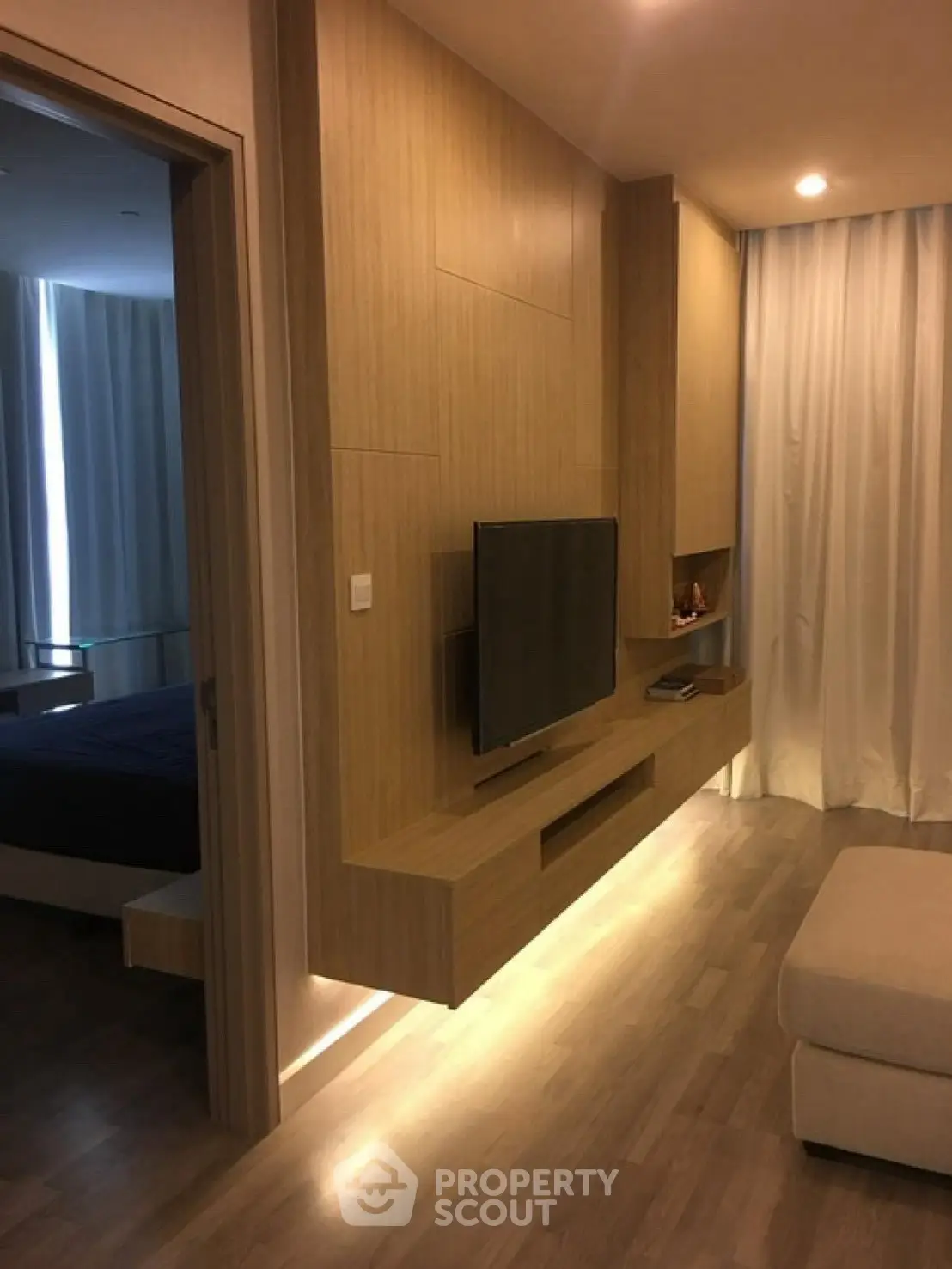 Modern living room with wood paneling and sleek TV setup