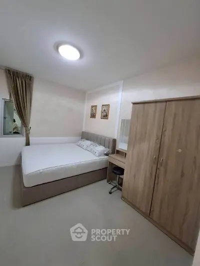 Cozy bedroom with modern furnishings and ample storage space