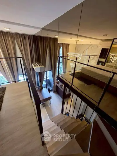 Luxurious modern loft with elegant staircase and floor-to-ceiling windows