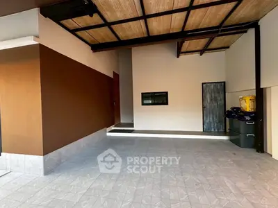 Spacious modern garage with tiled flooring and wooden ceiling accents.