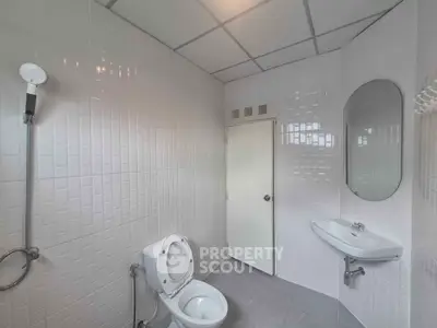 Modern bathroom with sleek white tiles and contemporary fixtures