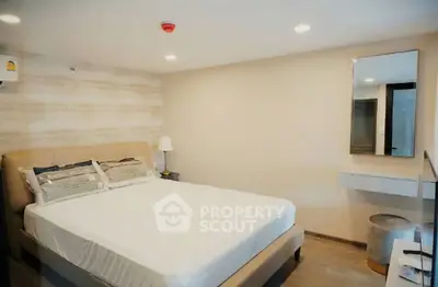 Modern bedroom with stylish decor and cozy ambiance, featuring a comfortable bed and elegant lighting.
